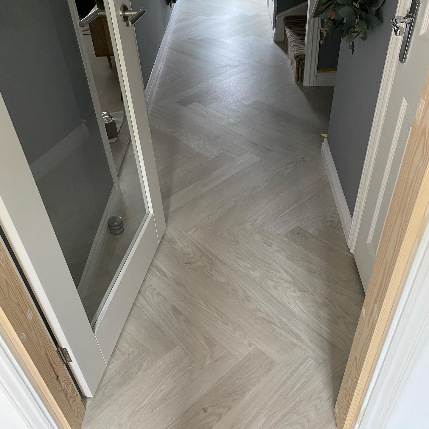 light grey herringbone wood flooring